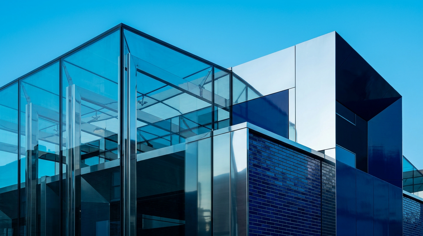 Modern glass and metal building with reflective panels and dark blue brick, designed in part by Chris Wise structural enginee