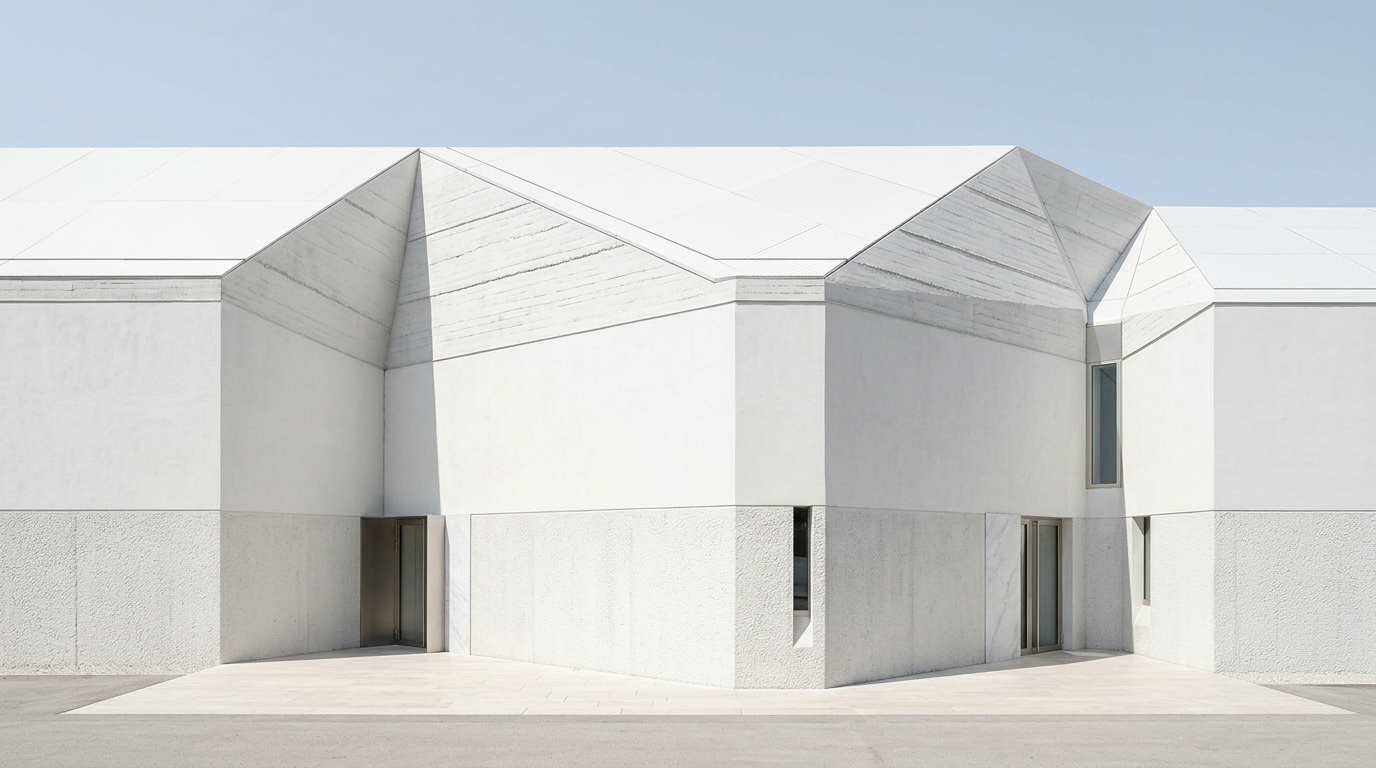 Modern white concrete building facade with textured lower walls and upper sections showing horizontal striations from rammed